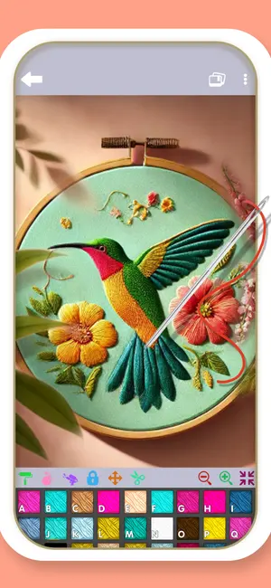 A hummingbird and hibiscus design being stitched in the app
